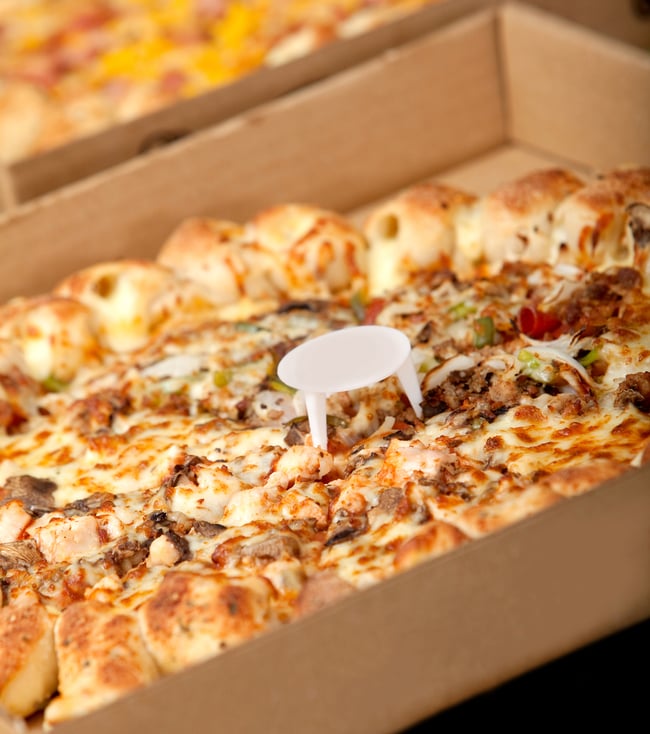 Delicious provocative pizza in a cardboard box